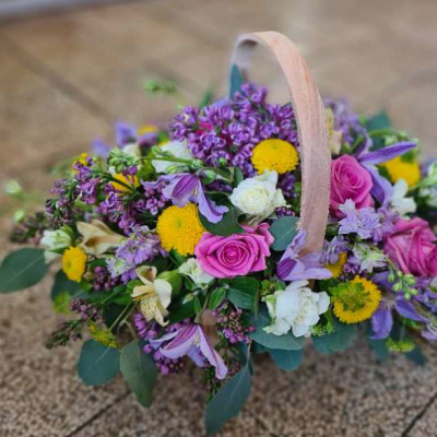Rustic Pink Basket - A charming basket arrangement filled with pink and purple flowers, perfect for creating a rustic and romantic ambiance.