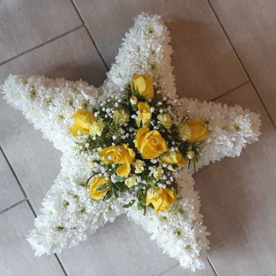 Star of Remembrance - A unique star-shaped floral arrangement with white chrysanthemums and yellow roses, designed to honour and remember a loved one.
