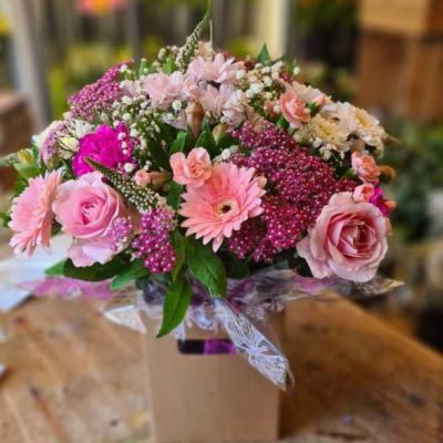 Pink Blossom Box - A delightful box arrangement with pink roses, pink gerberas, and seasonal flowers, great for expressing affection and care.